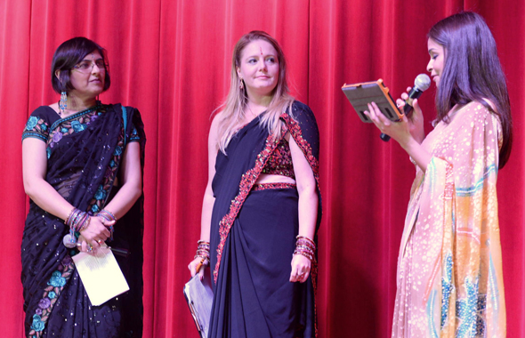 The emcees, Priyanka Desai of Music Masala radio show and Chrictine Dobbyn (centered), reporter with KTRH-ABC Channel 13 TV being introduced onstage.