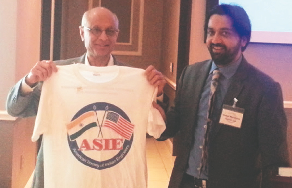 ASIE Member and Past Board Member Chad Patel (left) receives a prize from ASIE President Vishal Merchant.