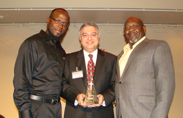 Nozer Buchia receiving the Distinguished Entrepreneur award from Barrim Clifton (left), President and Richard Singleton, Vice President of the Leadership Academy of the Carol Vance Unit.