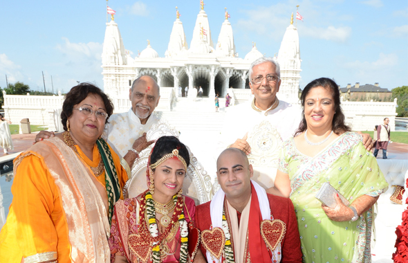 The newlyweds with their parents after the wedding ceremony at the BAPS Shree Swaminarayan Mandir.