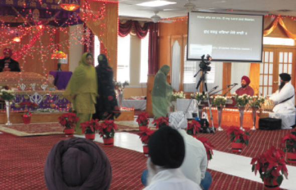 The sanctuary of the Sikh Center was colorfully decorated with red poinsettias in the aisle.  Photos: Jawahar Malhotra