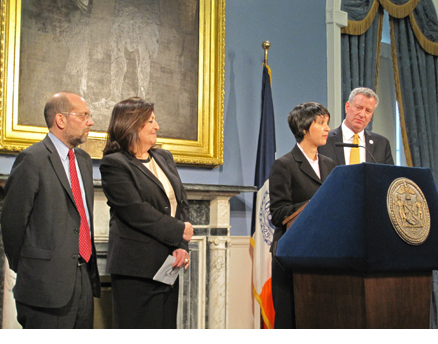 Nisha Agarwal (2nd from right) addresses a press conference in New York Feb. 28, after being named by New York Mayor Bill de Blasio (right) to head his Office of Immigrant Affairs.