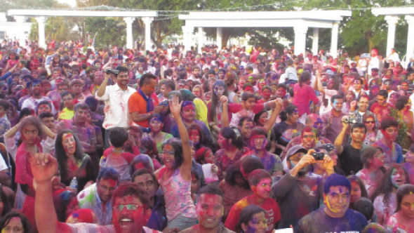Attendees having fun during the Holi celebrations.