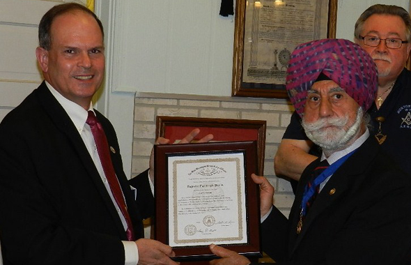 Right Worshipful Charles Cupples, District Deputy Grand Master for Masonic District 108 (left) presents the award to Raj Bhalla while Secretary Jim Starks looks on.