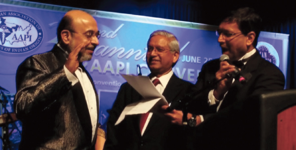 Dr. Jayesh Shah administering the oath of office to Dr. Ravi Jahagirdar. Also in the picture is Dr. Shashi Shah, Chairman, Board of Trustees, AAPI.