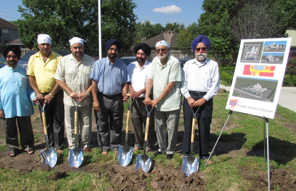 The Building Committee members and major donors pose with the ceremonial shovels at the groundbreaking ceremony.
