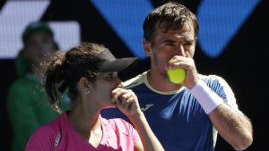Sania Mirza, left, and partner Ivan Dodig of Croatia chat during their mixed doubles semifinal against Australians Samantha Stosur and Sam Groth at the Australian Open tennis championships in Melbourne on Friday. (AP)