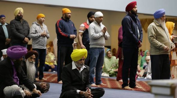 Men and women attend Sunday services at the Gurudwara Singh Sabha of Washington, a Sikh temple in Renton, Wash., Sunday, March 5, 2017, south of Seattle. Authorities said a Sikh man said a gunman shot him in his arm Friday, March 3, 2017, as he worked on his car in his driveway and told him “go back to your own country.” (AP Photo)