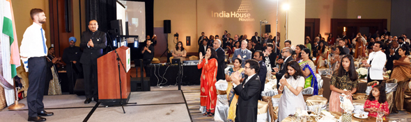 Ian Grillot (left) receives applause and cheers from India House Gala Chair Jiten Agarwal (center) and the audience at the India House Gala on March 25 in Houston. Photo: Bijay Dixit