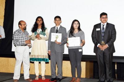 Children receiving awards from Mahesh Wadhwa