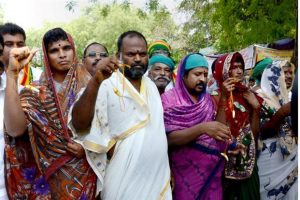 Protesting Tamil Nadu farmers dress as women as they continue with their demand seeking compensation for drought in the state on Saturday in New Delhi. Photo: PTI
