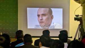 In this March 29, 2016 photo, journalists look at an image of Indian naval officer Kulbhushan Jadhav, who was arrested in March 2016, during a press conference by Pakistan's army spokesman. Security officials said the Pakistani army officer’s abduction was aimed at pressuring Pakistan to release Kulbhushan Jadhav.(AP Photo)