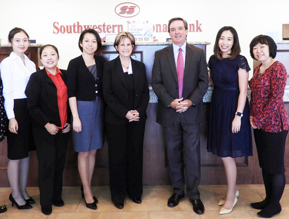 President /CEO Gary Owens, Senior Vice President Operation Officer Joy Langston, Senior Vice President and Chief Financial Officer Betsy Reese, Operations Officer Jenny Chien with Sugar Land Branch employees.