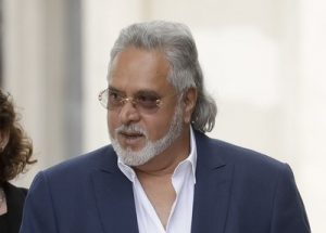 Former Indian politician and billionaire businessman Vijay Mallya, centre, arrives for his extradition hearing arrives at Westminster Magistrates Court in London, Tuesday, June 13, 2017. Mallya was arrested in London in April on behalf of authorities in India, where he is wanted on charges of money laundering and bank demands that he pay back more than a billion dollars in loans extended to his now-defunct airline. (AP Photo/Matt Dunham)