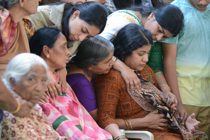 Sunayana Dumala (R), wife of killed Indian engineer Srinivas Kuchibhotla, who was shot dead in the US state of Kansas, is consoled by family members prior to performing the last rites at his funeral in Hyderabad on February 28, 2017. Thousands of Indians visit the United States every year for work or study, and the killing of 32-year-old engineer Srinivas Kuchibhotla in a Kansas bar last week has caused shockwaves around the country. / AFP / NOAH SEELAM        (Photo credit should read NOAH SEELAM/AFP/Getty Images)