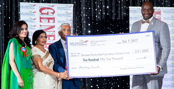 Houston Vice Mayor Pro Tem Jerry V. Davis (District B) accepts a replica of the $251,000 check from Guests of Honor and chief benefactor Swatantra Jain and his wife Bimla. IACF President Vanitha Pothuri is on the extreme left, during the IACF Gala on Saturday, October 7 at the Stafford Centre. Photos: Roy Photography