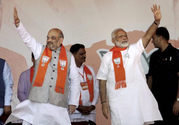 Prime Minister Narendra Modi with BJP president Amit Shah during the BJP rally in Gandhinagar on Monday. Photo: PTI