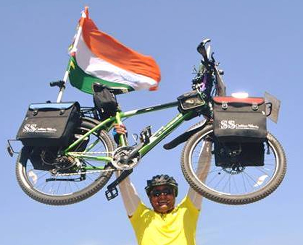 Sharma holding the bike that has served him over thousands of miles across the world. 