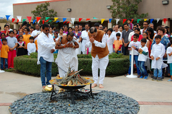 The priest, Sri Ganesh Satyanarayana and Acarya Gaurang Nanavaty doing puja, as they light the sacred Holi bonfire.