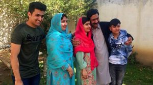 Pakistan’s Nobel Peace Prize winner Malala Yousafzai, center, poses for a photograph with her family members at her native home during a visit to Mingora, the main town of Pakistan Swat Valley, Saturday, March 31, 2018. AP