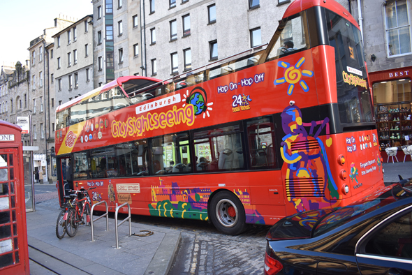 A colorful double-decker hop on-hop off tourist bus