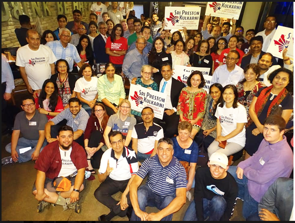 Sri Kulkarni (center) celebrates the landslide win in District 22 runoff with his mother Margaret (left) and room full of volunteers at the victory party in Sugar Land.