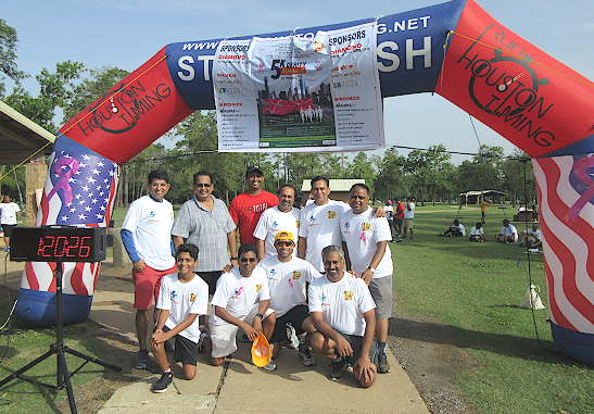 The organizers of the AKKA 5K charity run/walk for Cancer Awareness at Bear Creek Park pose under their start-stop archway last Sunday, August 12. AKKA President Shivamurthy Keelara is kneeling, second from left.